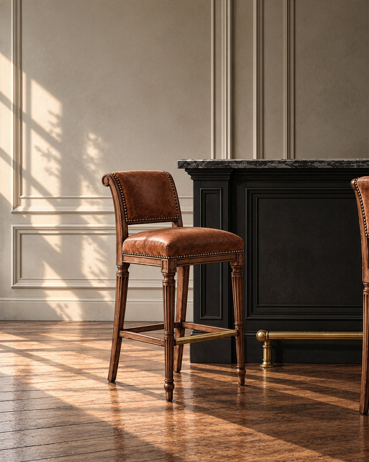 Bramley House bar and counter stools: a nailhead-trimmed leather bar stool with fluted legs at a panelled bar with a brass footrail.