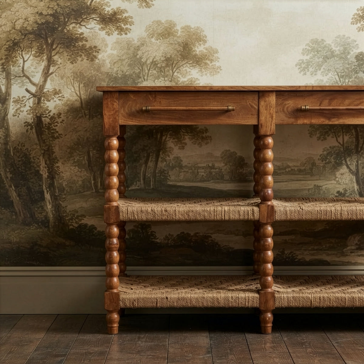 Bramley House consoles, cabinets and sideboards: a bobbin-leg console with woven shelves against a scenic mural wall.