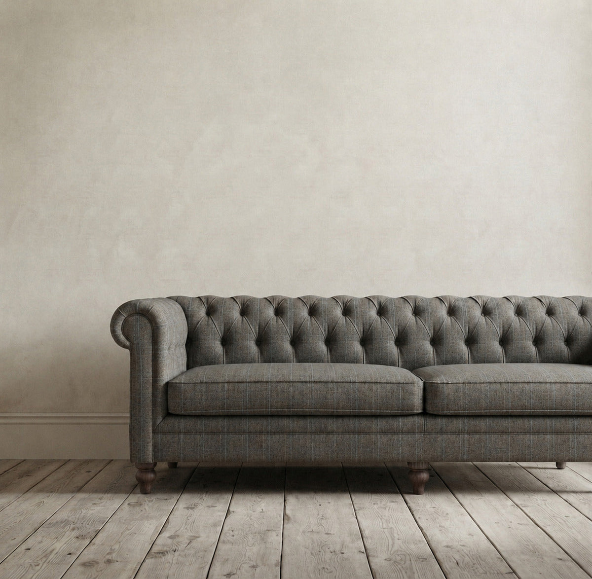 Bramley House sofas and loveseats: a tufted chesterfield sofa in grey wool plaid against a limewashed plaster wall.