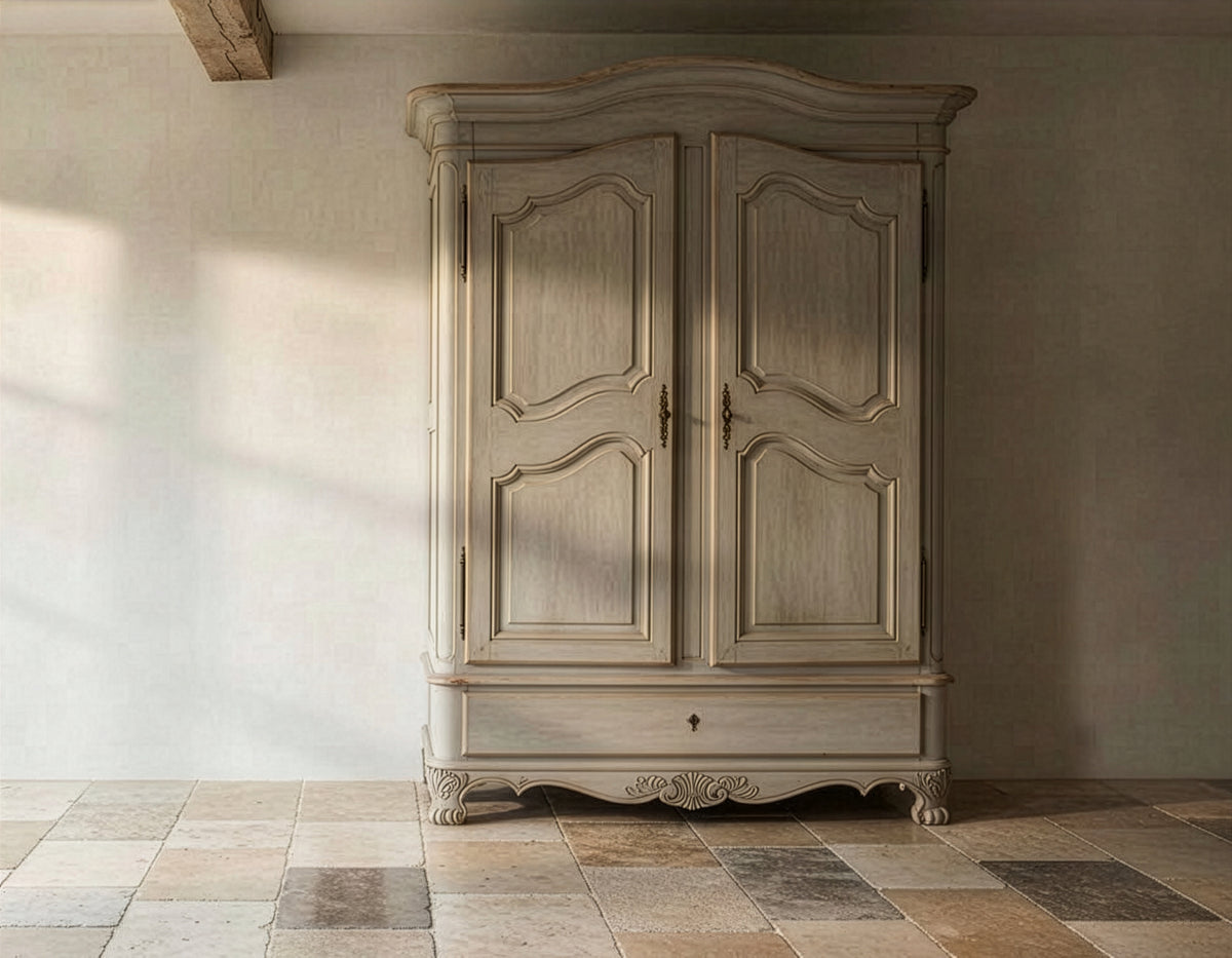 Bramley House storage furniture: a bonnet-top armoire with carved detailing and a base drawer on a flagstone floor.