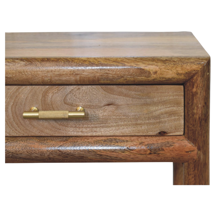 Close view of the brass hardware on the Ashcombe Bedside Table with Woven Shelf in Amber.