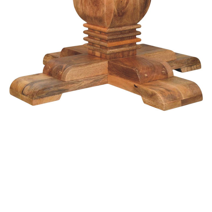 Close view of the sculpted base on the Ashford Round Pedestal Table in Amber.