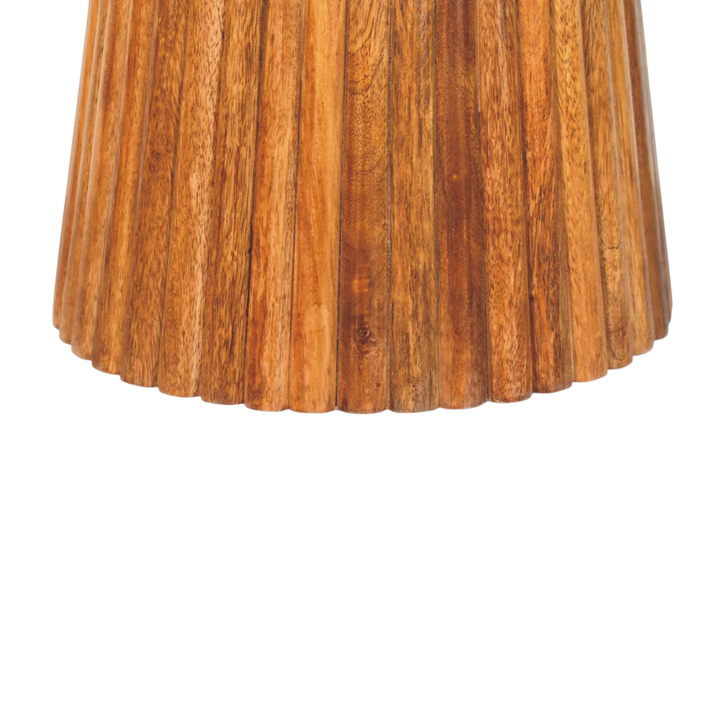 Close view of the base on the Capri Fluted Pedestal Table in Amber.