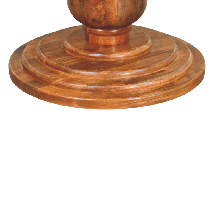 Close view of the sculpted base on the Cavendish Round Dining Table in Chestnut.