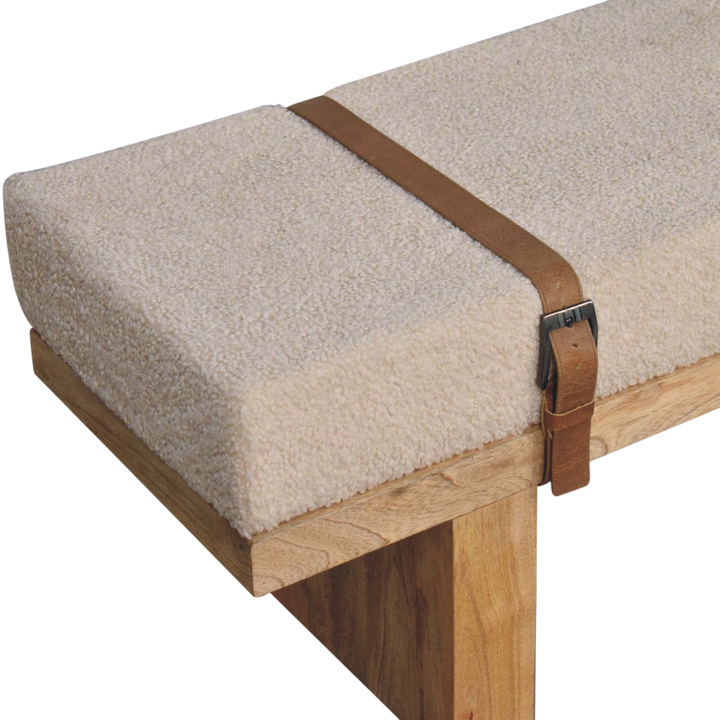 Close view of the strap and buckle on the Chamonix Buckled Bench in Cream Bouclé with Tobacco Leather.
