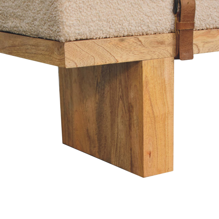 Close view of the legs on the Chamonix Buckled Bench in Cream Bouclé with Tobacco Leather.