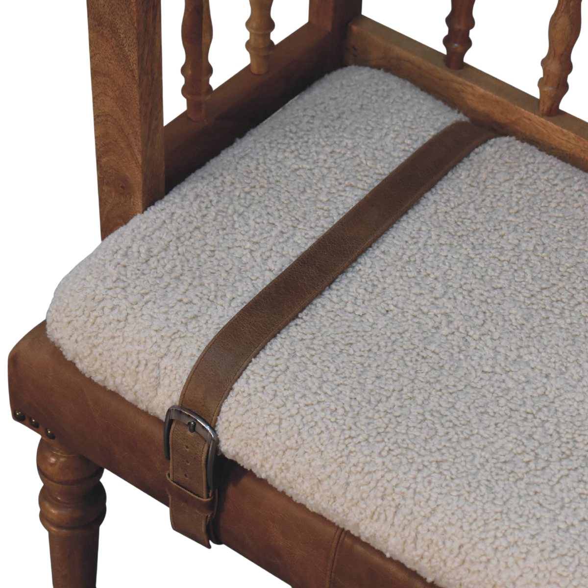 Close view of the strap and buckle on the Chamonix Carved Hall Bench in Cream Bouclé with Tobacco Leather.