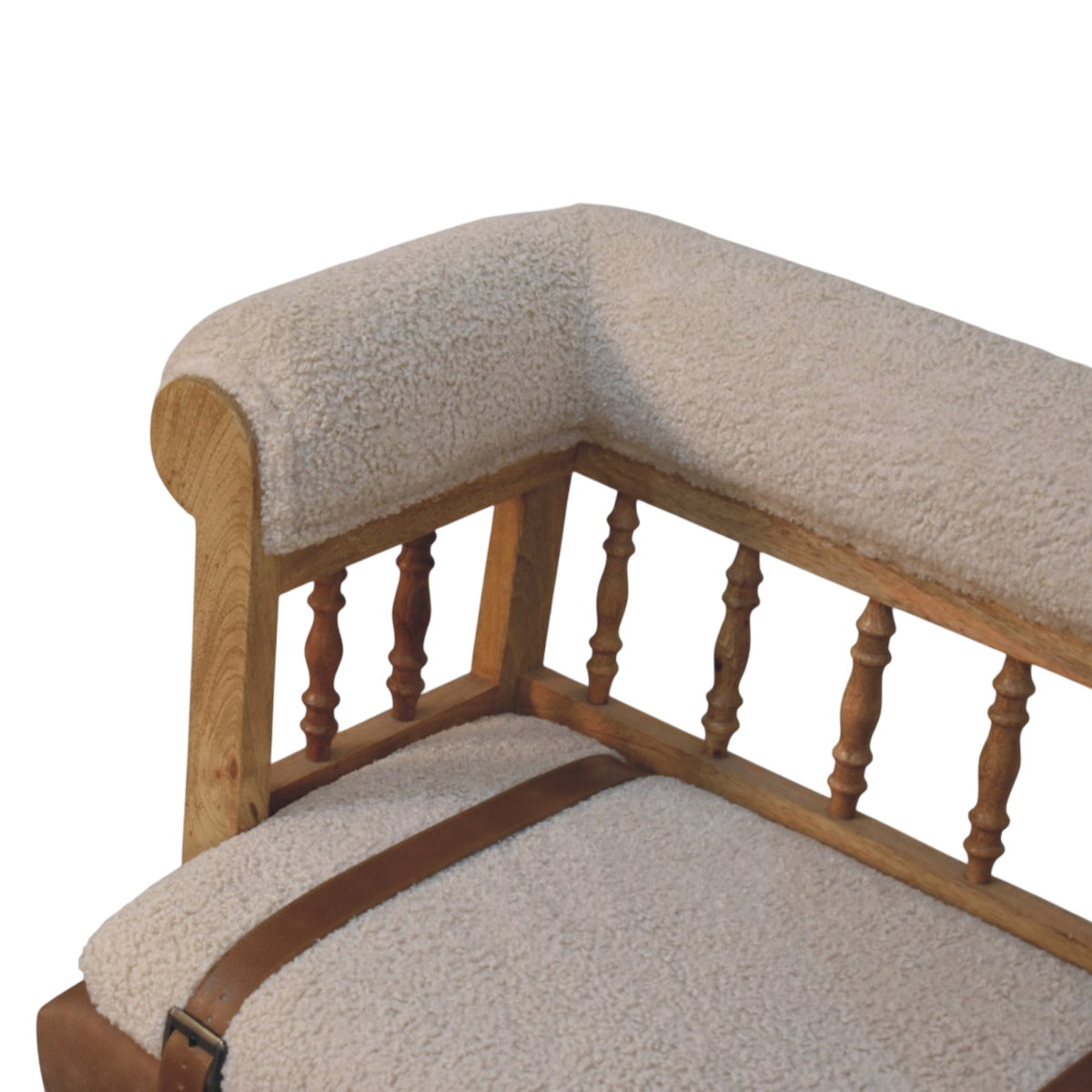 Close view of the arm on the Chamonix Spindle-Back Bench in Cream Bouclé with Tobacco Leather.