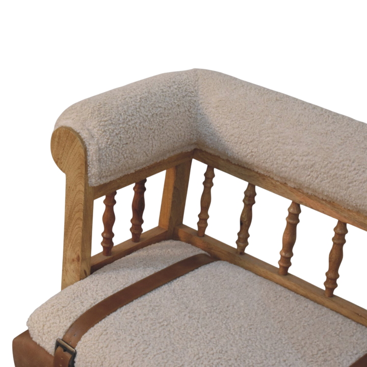 Close view of the arm on the Chamonix Spindle-Back Bench in Cream Bouclé with Tobacco Leather.