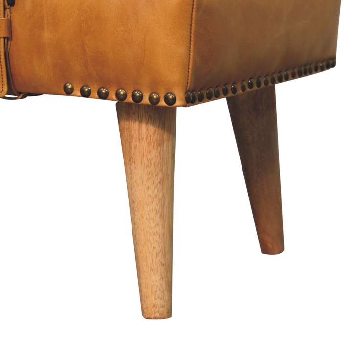 Close view of the turned legs on the Chamonix Strap Bench in Cream Bouclé with Blonde Saddle.