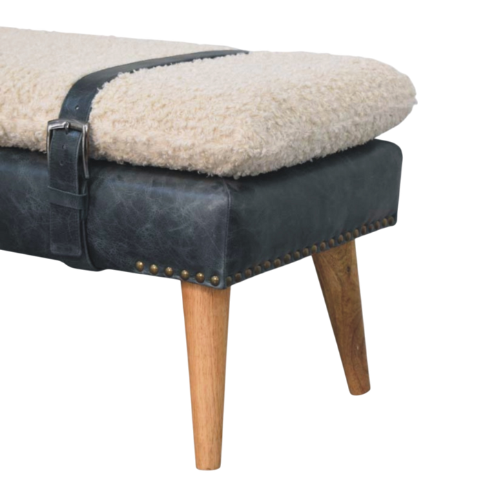 Close view of the turned legs on the Chamonix Strap Bench in Cream Bouclé with Charcoal Leather.