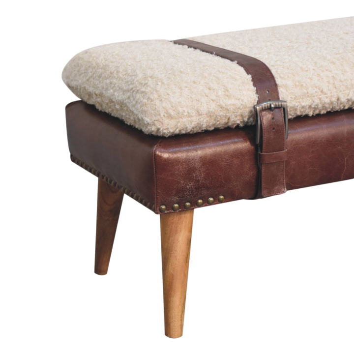 Close view of the turned legs on the Chamonix Strap Bench in Cream Bouclé with Cognac Leather.