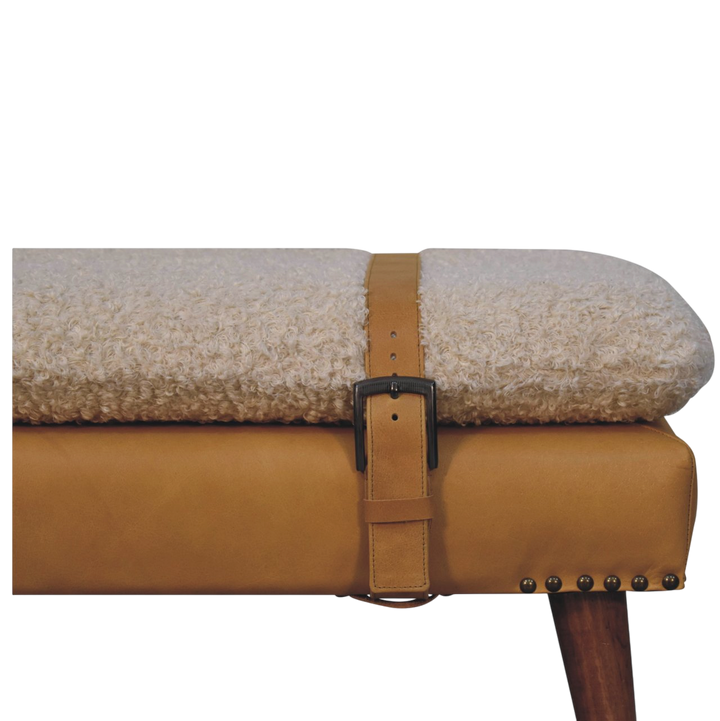 Close view of the strap and buckle on the Chamonix Strap Bench in Cream Bouclé with Tobacco Leather.