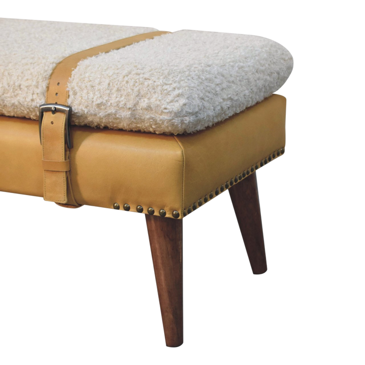 Close view of the turned legs on the Chamonix Strap Bench in Cream Bouclé with Tobacco Leather.