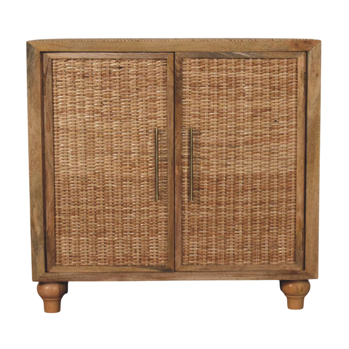 Comporta 2-Door Cabinet in Amber with Natural Rattan, front view. 100% solid hardwood in a warm amber finish, two handwoven rattan door panels, brass handles, interior shelving.