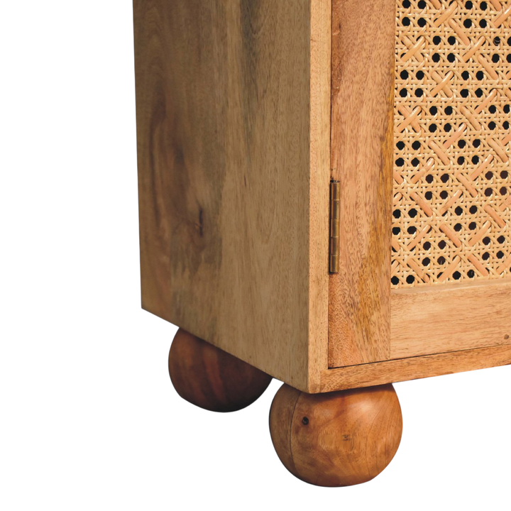 Close view of the feet on the Comporta Arched Cane Cabinet in Amber with Natural Rattan.