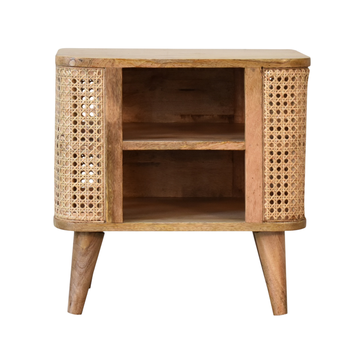 Comporta Open Bedside Table in Amber with Natural Rattan, front view. 100% solid hardwood in a warm amber finish, woven rattan panels, open body, two small drawers, tapered legs.