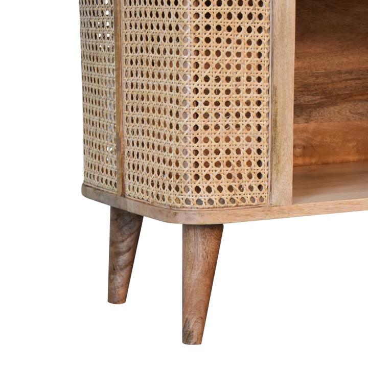 Close view of the legs on the Comporta Open Cabinet in Amber with Natural Rattan.