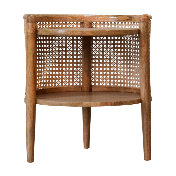 Comporta Round Bedside Table in Amber with Natural Rattan, front view. 100% solid hardwood in a warm amber finish, round body, woven rattan surround, two circular drawers.