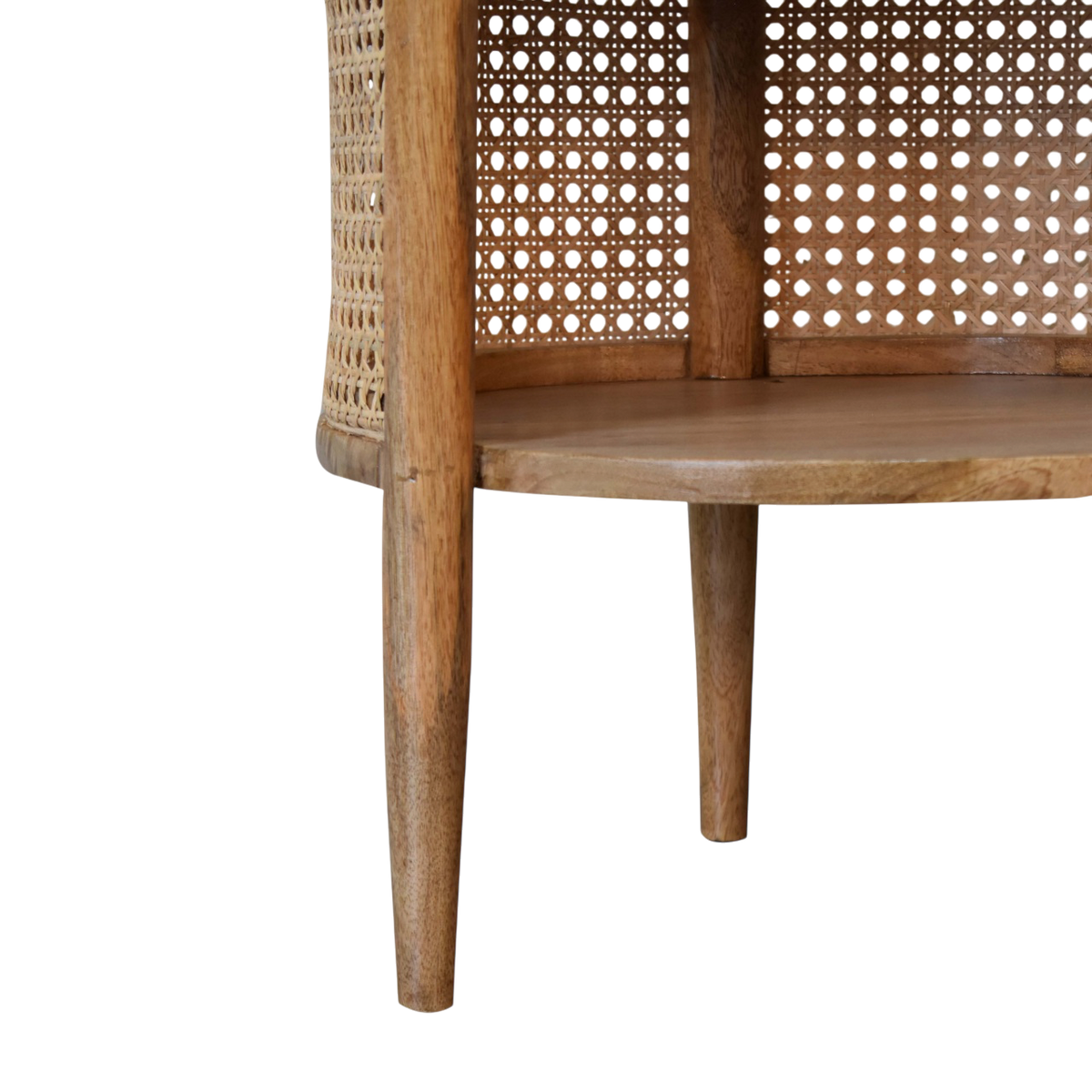 Close view of the shelf on the Comporta Round Bedside Table in Amber with Natural Rattan.