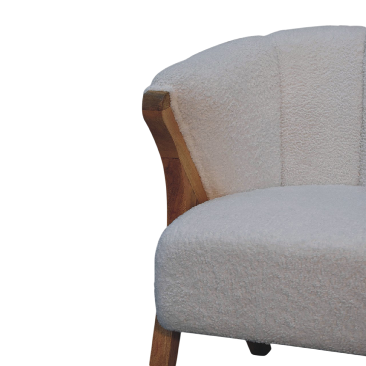 Close view of the joinery on the frame on the Delano Bouclé Lounge Chair in Chestnut and Alabaster Bouclé.
