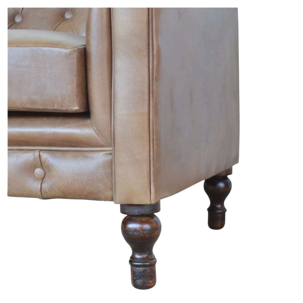 Close view of the turned legs and castors beneath the Fitzroy Chesterfield Loveseat.