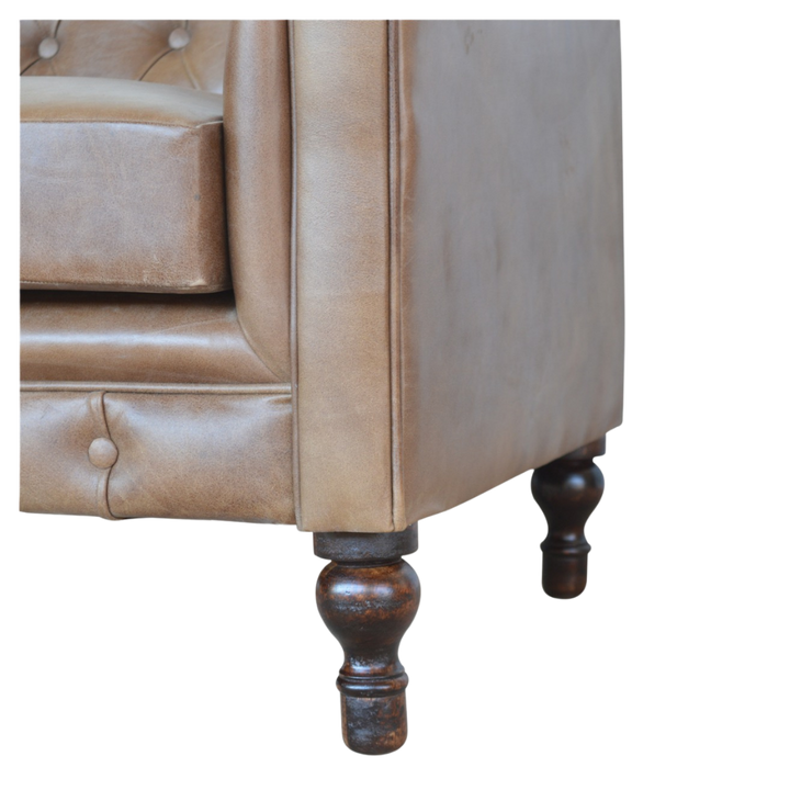 Close view of the turned legs and castors beneath the Fitzroy Chesterfield Loveseat.