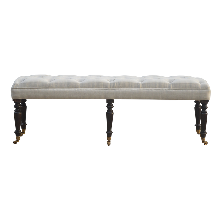 Grosvenor Hall Bench in Espresso and Alabaster, front view. Deep-buttoned cotton on hand-turned legs with brass castors.