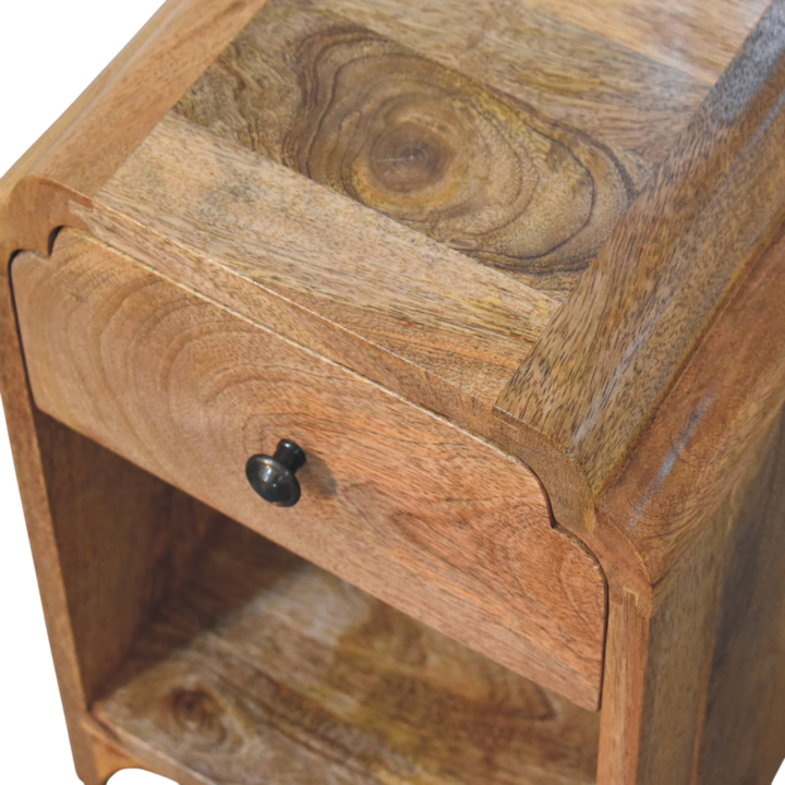 Close view of the carved detailing on the Hadley Mini Bedside Table in Amber.