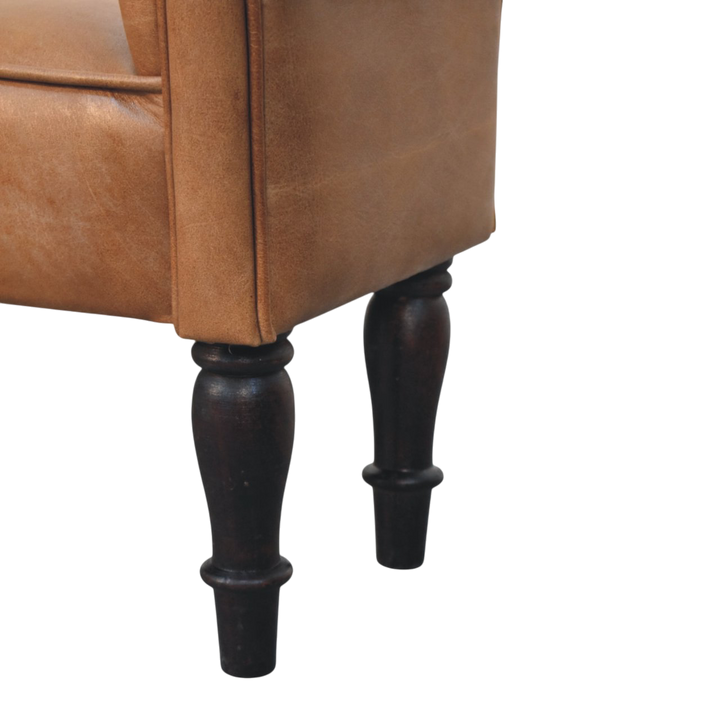 Close view of the turned legs on the Hampstead Roll-Arm Bench in Tobacco Leather.