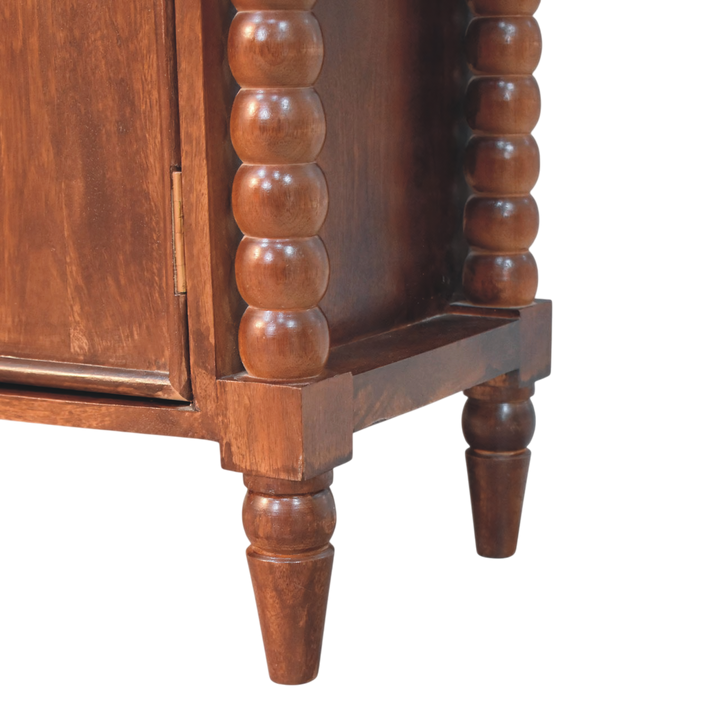 Close view of the bobbin turning on the Langham 2-Door Cabinet in Claret.