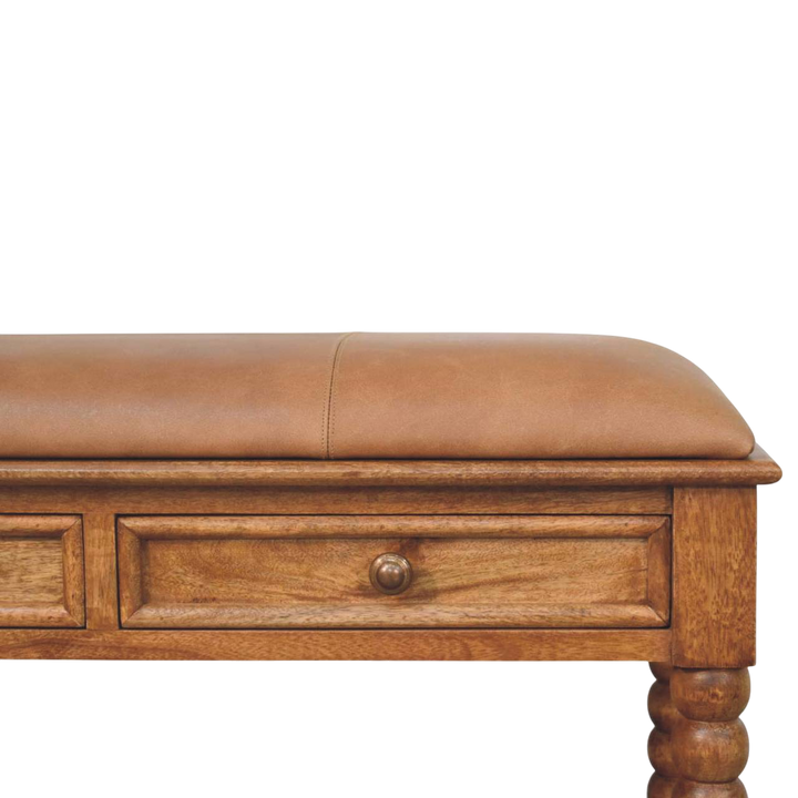 Close view of the upholstered seat on the Langham Bobbin Bench in Amber with Tobacco Leather.