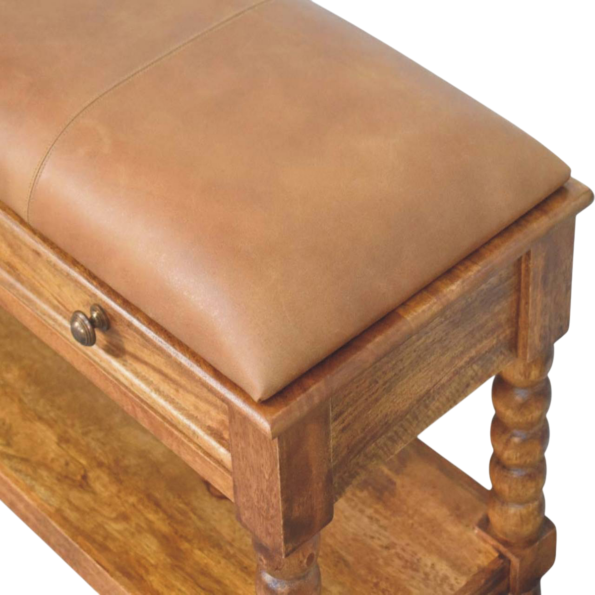 Close view of the drawer front and knob on the Langham Bobbin Bench in Amber with Tobacco Leather.