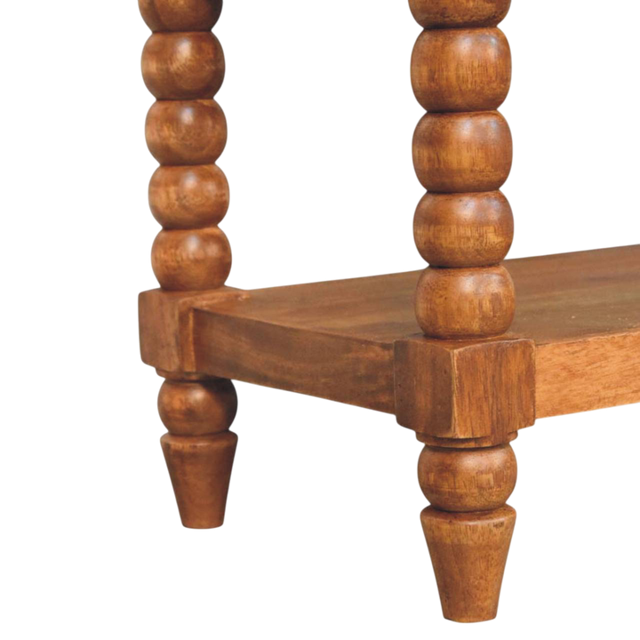 Close view of the turned legs on the Langham Bobbin Bench in Amber with Tobacco Leather.