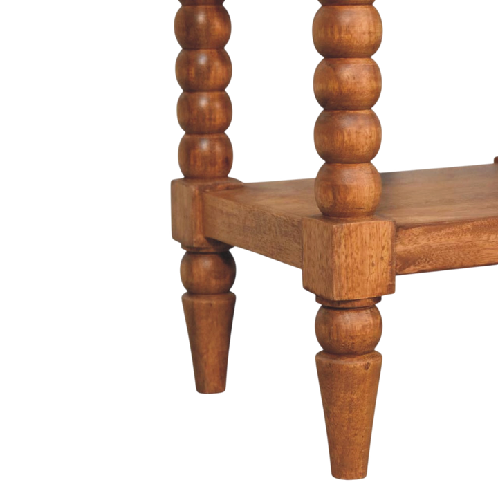 Close view of the bobbin turning on the Langham Open Bedside Table in Amber.