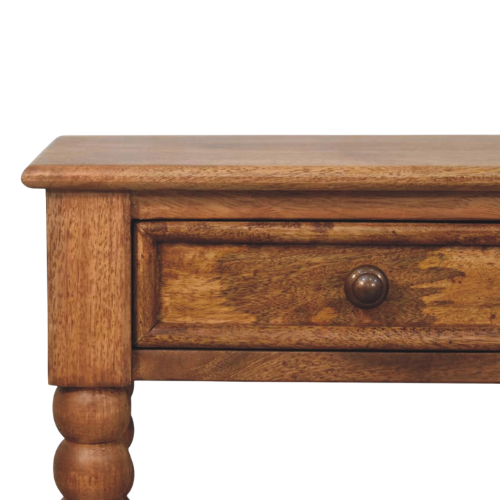 Close view of the drawer front on the Langham Open Bedside Table in Amber.