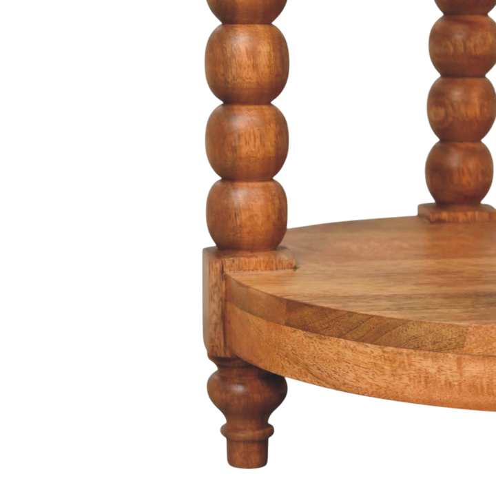 Close view of the bobbin turning on the Langham Round Side Table in Amber.