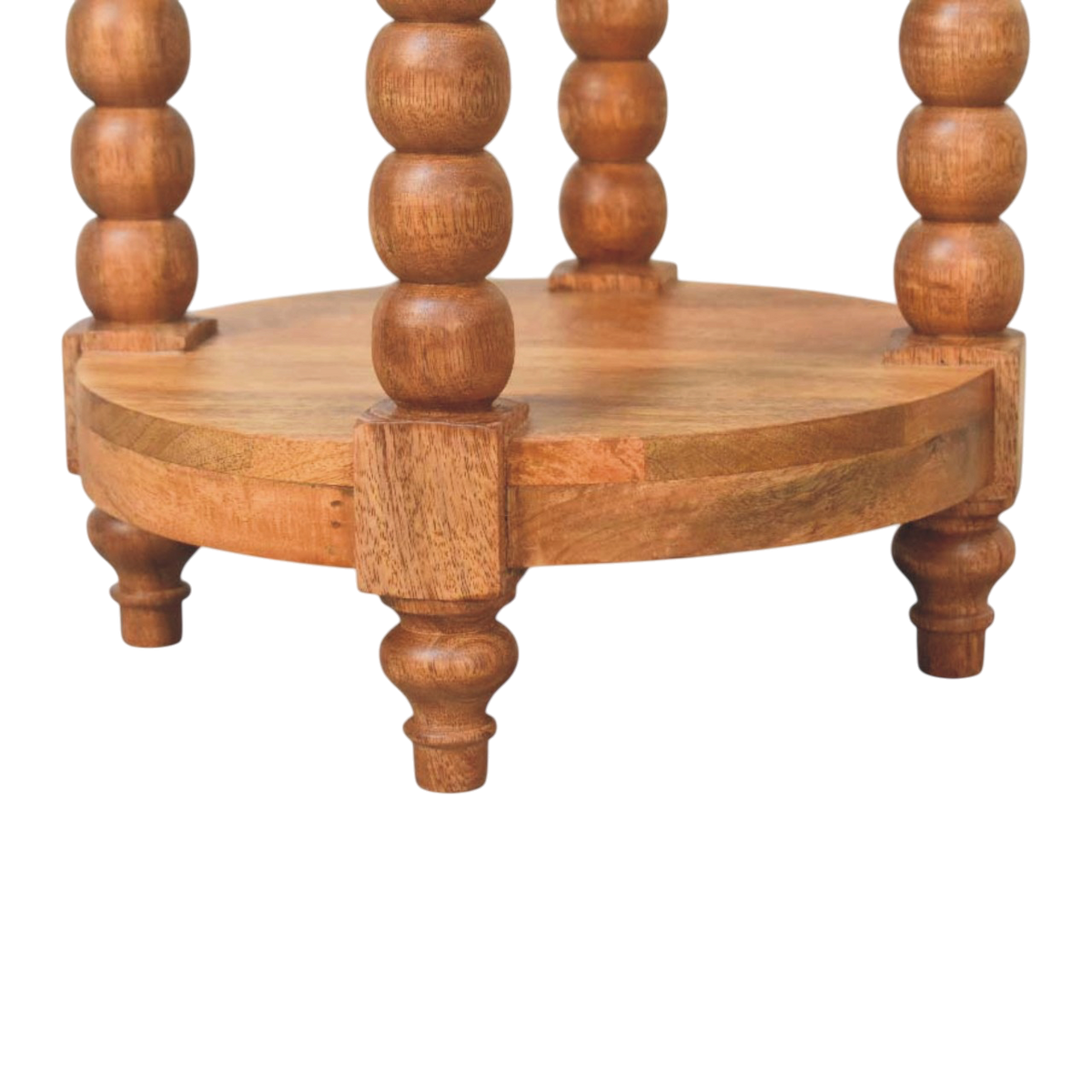 Close view of the shelf on the Langham Round Side Table in Amber.