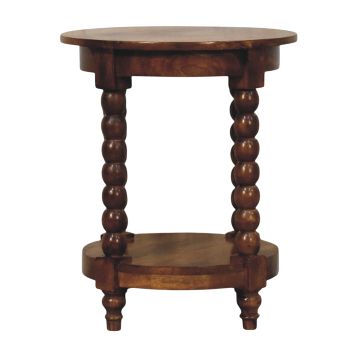 Langham Round Side Table in Russet, front view. Russet hardwood with turned spindle legs and an open lower shelf.