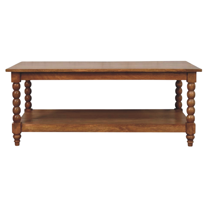 Langham Spindle Coffee Table in Amber, front view. 100% solid hardwood in a warm amber finish, turned spindle legs, open lower shelf.