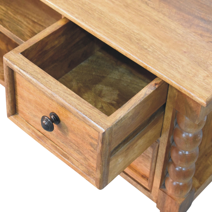 Langham Spindle Media Unit in Amber, shown with a drawer open.