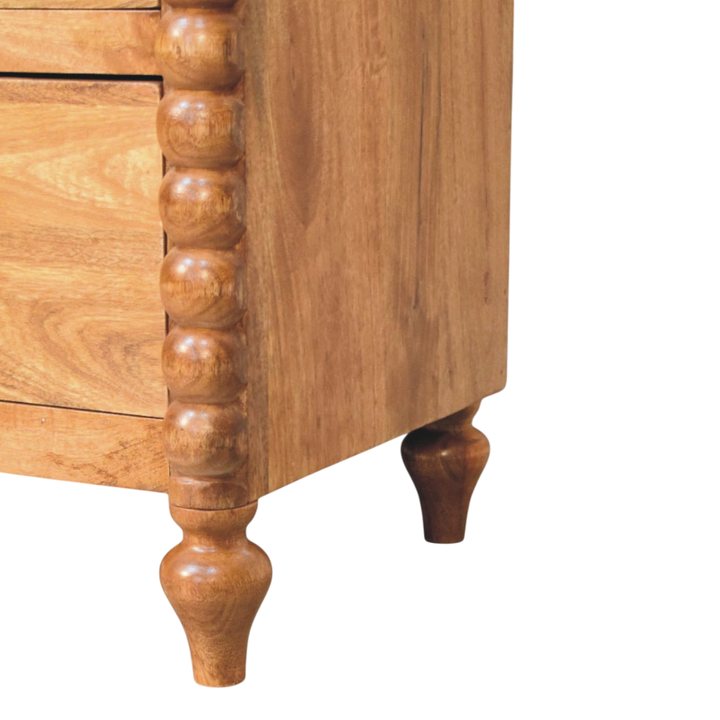 Close view of the legs on the Langham Wide 3-Drawer Dresser in Amber.