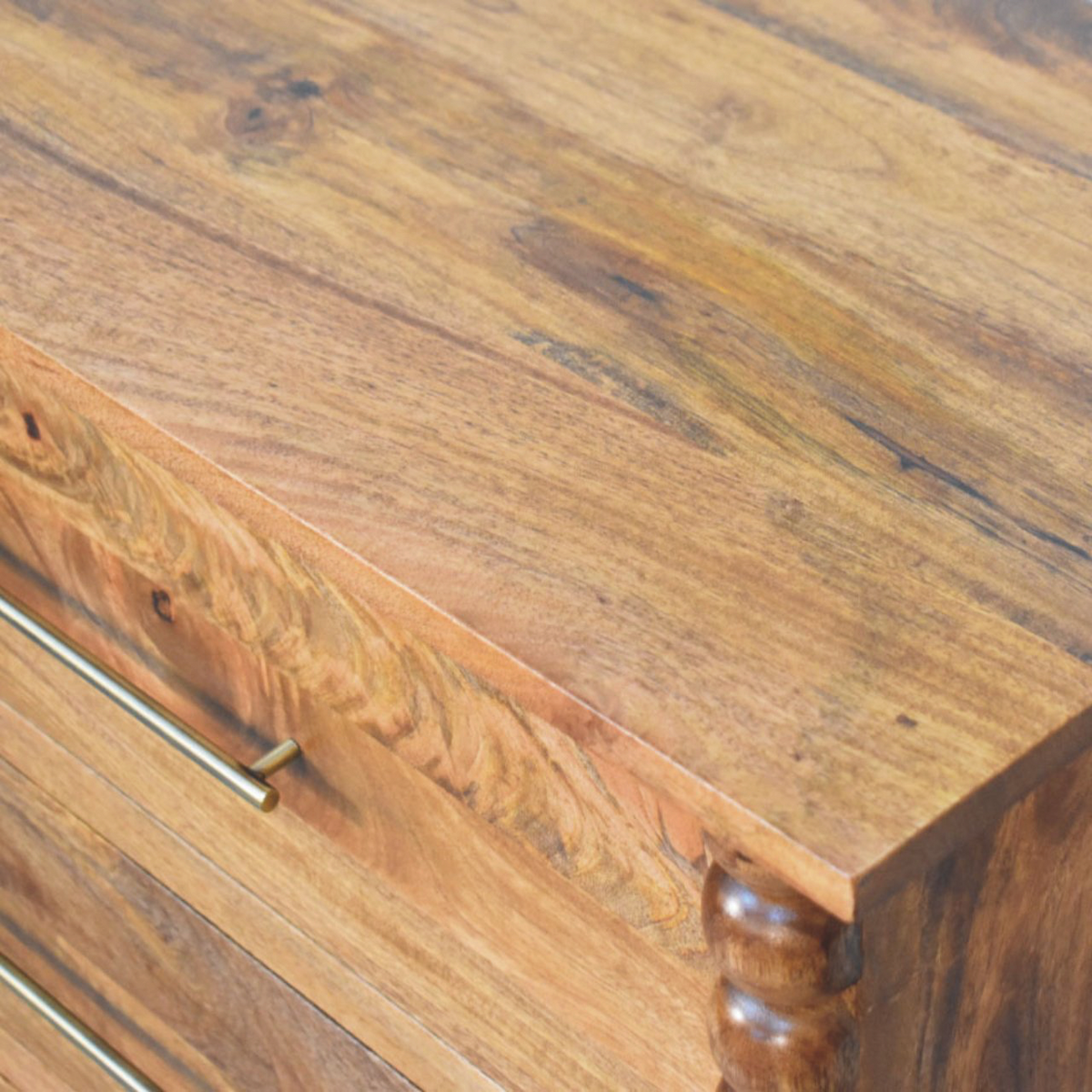 Close view of the brass hardware on the Langham Wide 3-Drawer Dresser in Amber.