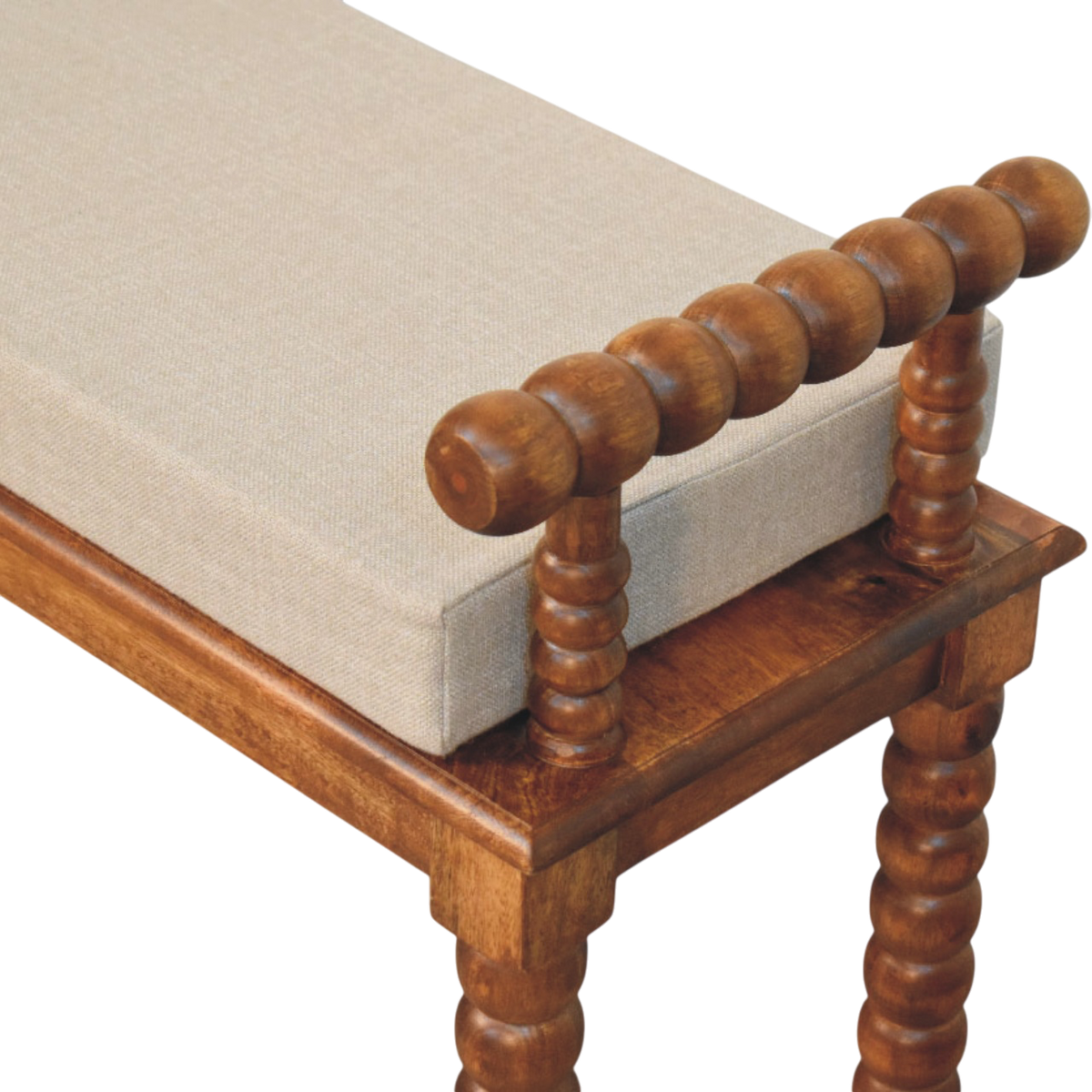 Close view of the bobbin-turned detailing on the Langham Window Bench in Amber with Clay Linen.