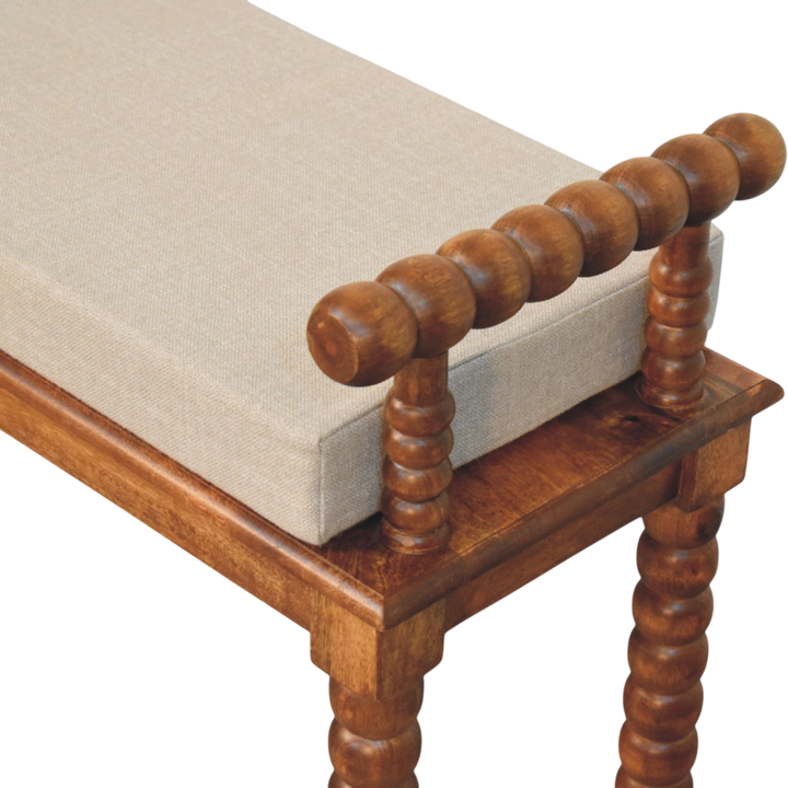 Close view of the bobbin-turned detailing on the Langham Window Bench in Amber with Clay Linen.