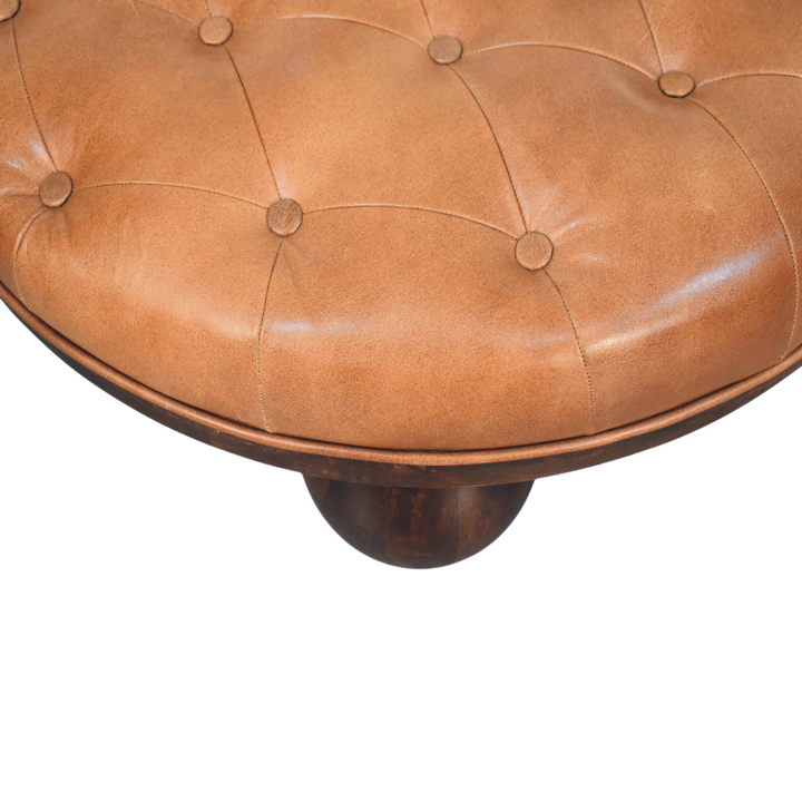 Close view of the hand-set buttoning on the Lucca Round Leather Coffee Table in Burnt Caramel.