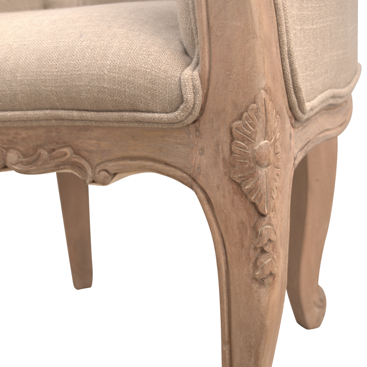 Close view of the hand-carved frame on the Mirabel Button-Back Chair in Clay Linen.