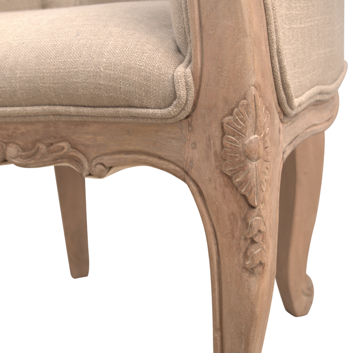 Close view of the hand-carved frame on the Mirabel Button-Back Chair in Clay Linen.