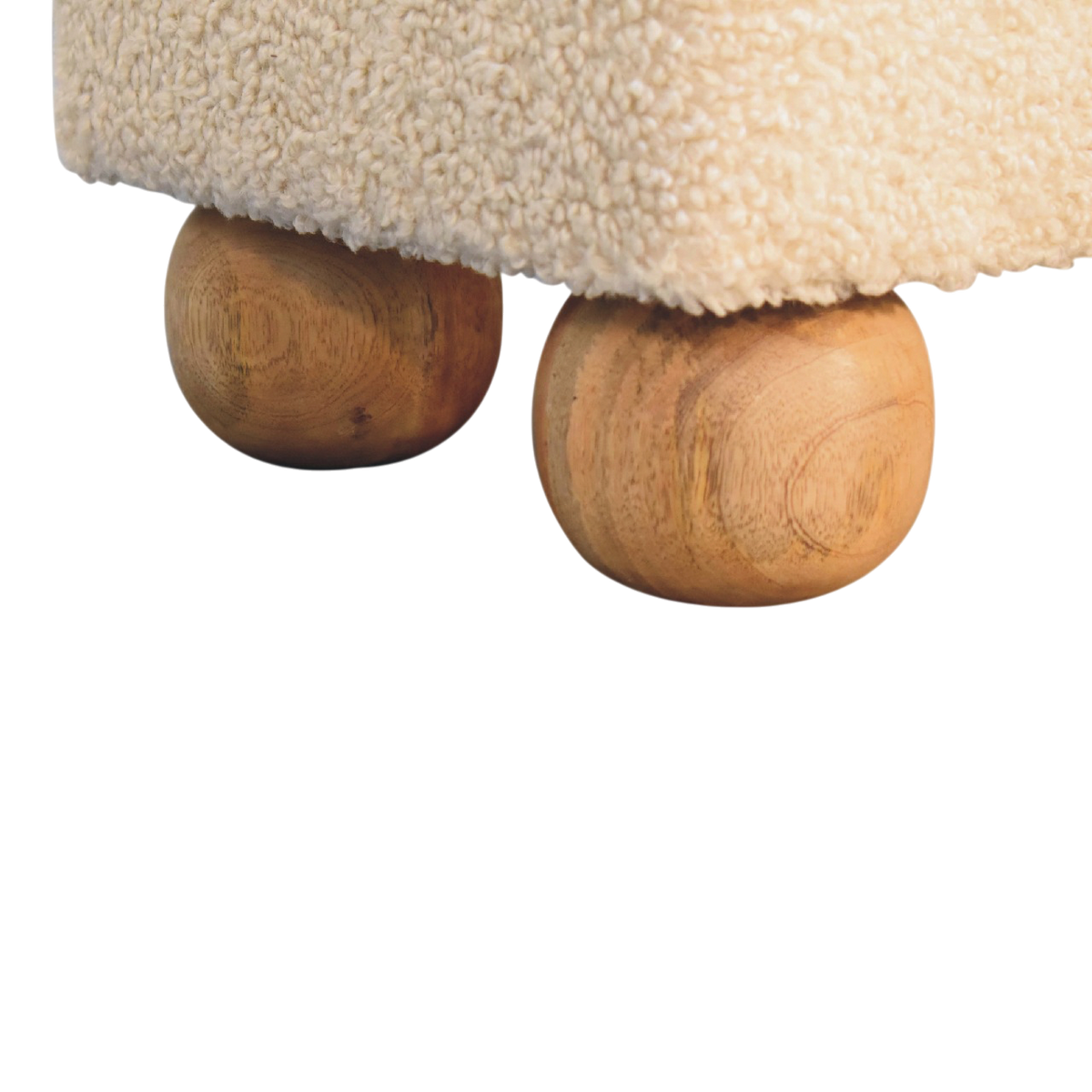 Close view of the feet on the Oakhurst Ball-Foot Footstool in Cream Bouclé with Cognac Leather.