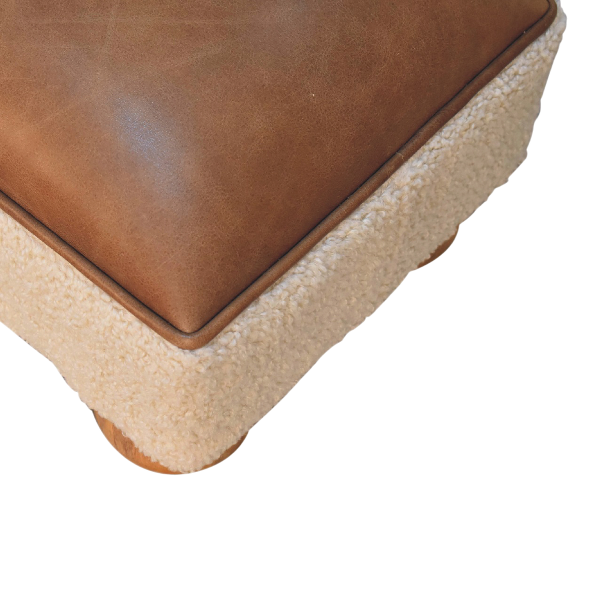 Close view of the seat on the Oakhurst Ball-Foot Footstool in Cream Bouclé with Cognac Leather.